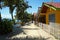 Sandy path along the sea with bungalows