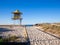 Sandy pathway entrance to the beach lifeguard tower, wooden rails Gold Coast Australia