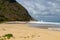 Sandy Praia da Conceicao beach under blue cloudy sky in Pernambuco, Brazil