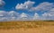 Sandy prairie under a dense  clouds