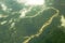 A sandy river bed among hilly green woodland. aerial photography white clouds over the valley