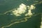 A sandy river beds among a green forest, view from a great height. white clouds above the ground. aerial photography