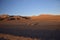 Sandy road through the desert at sunrise in Eduardo Avaroa National Reserve in Uyuni, Bolivia.