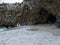 Sandy seashore with narrow passage through the rocky coastline