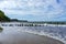 A sandy seashore. Old breakwaters. Sandy shore and storm at sea