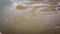 Sandy seashore, top view. Minimalistic seascape, a copy space. Wet sand. Natural background, texture. Peaceful beach background,