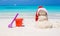 Sandy snowman with red Santa Hat and beach toys