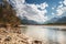 Sandy and stony river bank and blue sky