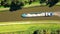 Sandy voyage: top-down aerial of cargo ship amidst green dikes