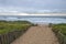 Sandy Walkway onto Beach Against Early Morning Overcast Skyline