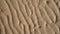 Sandy wave of the sea at low tide, Wavy curves pattern of sand beach, Texture background.