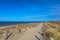 Sandy way on top of the dunes, leading along the beach