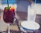 Sangria glass with white plate and water cup in background