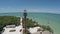 Sanibel Island Light House aerial fly in then over to water beach ocean