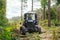 Sanitary cleaning of the forest. Tractor working in a forest. forestry