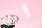 Sanitary napkin with beautiful peonies on pink background, health care, monthly protection, reliable friend
