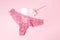 Sanitary napkin with a beautiful peony and underwear on a pink background, health care, monthly protection, reliable friend