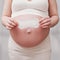 Sanitary napkin in the hands of a pregnant woman, home living room