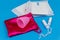 Sanitary pad, tampons and menstrual cup on blue background. Concept of critical days, menstruation, feminine hygiene