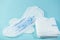 Sanitary pads and absorbent sheets on a blue background