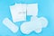 Sanitary pads and absorbent sheets on a blue background
