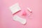 sanitary pads, menstrual cup and tampon isolated on pastel pink background, top view, flat lay