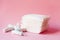 Sanitary pads and tampons on pink background