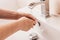 Sanitary treatment - woman lathers hands in bathroom
