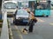 Sanitation workers in the removal of roadside weeds