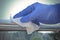 Sanitization of surfaces in public places - hand in disposable glove