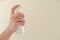 Sanitizer. Hand antiseptic.White bottle of antibacterial product in female hands Isolated on a beige background.