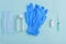 Sanitizer, medical gloves, medical mask, ampoule, syringe on blue background, protective equipment concept, vaccination,