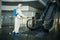 Sanitizing worker disinfects the escalator with a spray at the empty shopping mall to prevent the covid-19 spread in public places