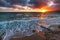 Sanremo, Riviera dei Fiori, Liguria, Italy. Scenis rocks and pebbles on beach illuminated beautiful by sunset light. Dramatic