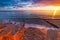 Sanremo, Riviera dei Fiori, Liguria, Italy. Scenis rocks and pebbles on beach illuminated beautiful by sunset light. Dramatic