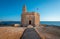 Sant Nicolau Castle in Ciutadella of menorca on the cliffs with blue summer sea and blue sky