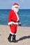 Santa on a beach walking