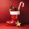 Santa boot with candy cane and baubles. Christmas. New Year red background with copy space