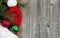 Santa cap with ornaments and evergreen branch on wooden boards