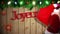 Santa carrying sack of gifts against festive wooden background