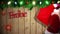 Santa carrying sack of gifts against festive wooden background