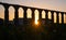 Santa Clara Aqueduct, Vila do Conde, Portugal at sunset with sun shining through arches