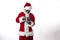 Santa Claus with alien mask wearing a smart phone on a white background