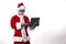 Santa Claus with alien mask wearing a tablet on a white background