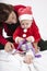 Santa claus baby and mom opening gift