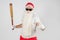 Santa Claus with a baseball bat in his hands. Isolated on white
