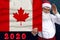 Santa Claus with a beard holds a beautiful photo of the colored national flag of the modern state of Canada with a festive date