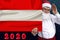 Santa Claus with a beard holds a beautiful photo of the colored national flag of the state of Austria with a festive date 2020,