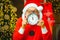 Santa Claus - bearded funny senior. Photo of Santa pointing at clock showing five minutes to midnight. Christmas time