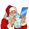 Santa Claus and a big smartphone. Electronic Christmas sales and orders in online stores